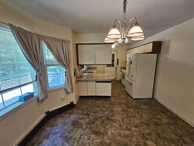 kitchen with pendant lighting, sink, white appliances, white cabinets, and a chandelier