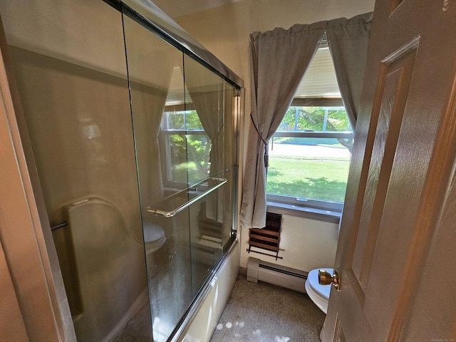 bathroom with toilet, enclosed tub / shower combo, and a baseboard radiator