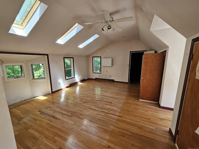 additional living space featuring lofted ceiling, ceiling fan, and light hardwood / wood-style flooring