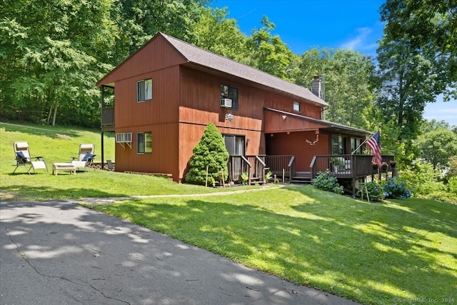 rear view of property featuring a yard