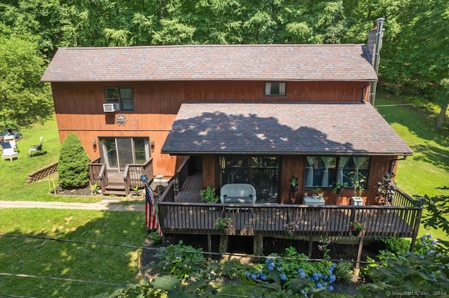 rear view of house featuring a yard and a wooden deck