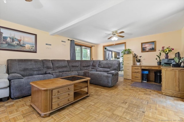 living room featuring ceiling fan, light parquet flooring, and beamed ceiling