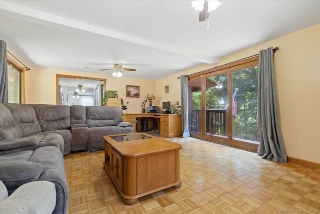 living room with ceiling fan, light parquet flooring, and beam ceiling