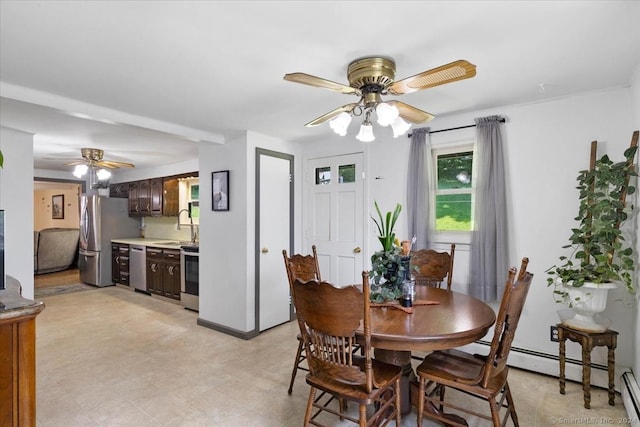 dining area featuring ceiling fan, baseboard heating, and sink