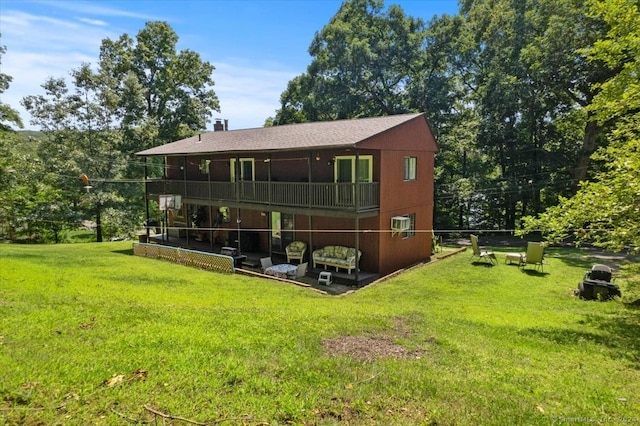 rear view of house featuring a yard