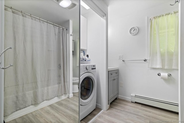 washroom featuring light wood-type flooring, washer / clothes dryer, and baseboard heating