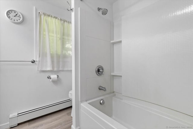 bathroom featuring toilet, baseboard heating, shower / tub combination, and hardwood / wood-style flooring