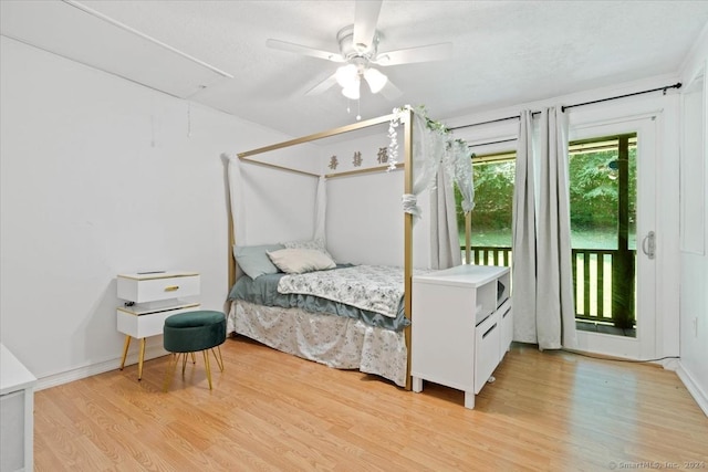 bedroom featuring ceiling fan, access to exterior, and light hardwood / wood-style floors