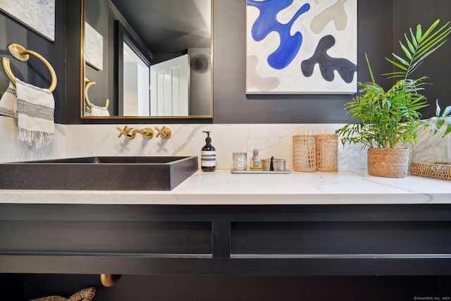 bathroom with vanity and tasteful backsplash