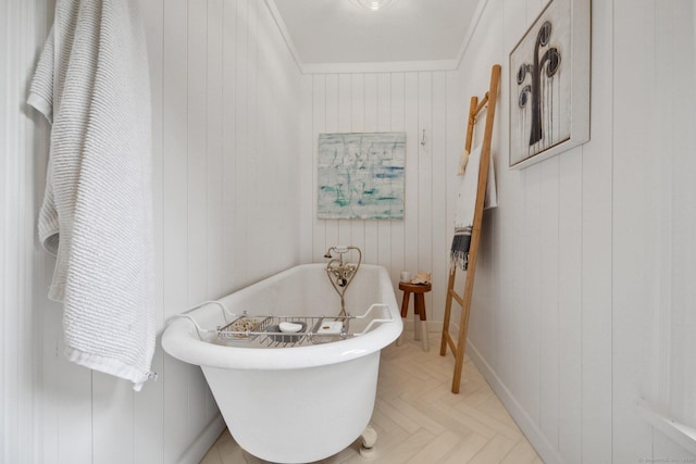 bathroom featuring a soaking tub and wooden walls