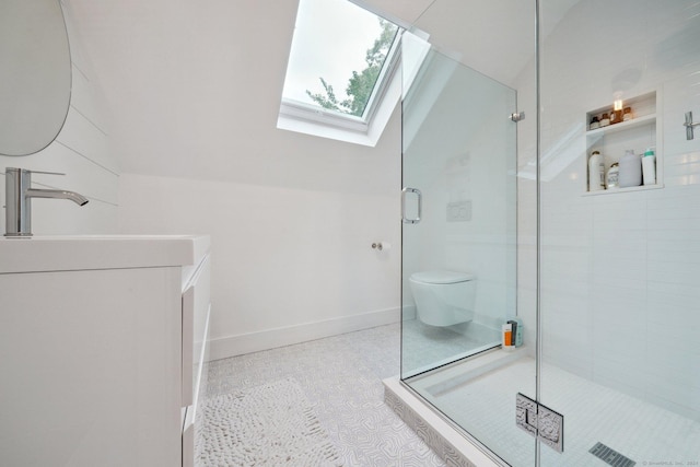bathroom with a skylight, a stall shower, a sink, baseboards, and toilet