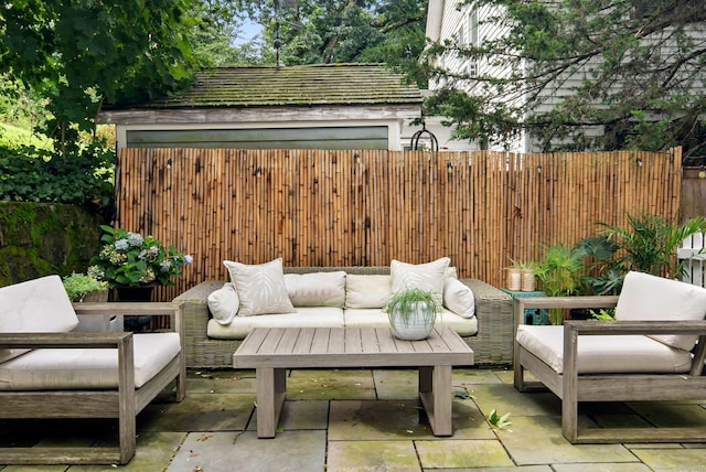 view of patio with an outdoor living space and fence