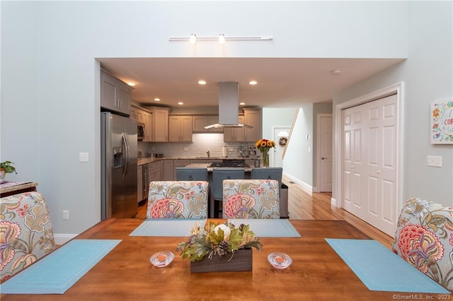 dining area with sink and light wood-type flooring