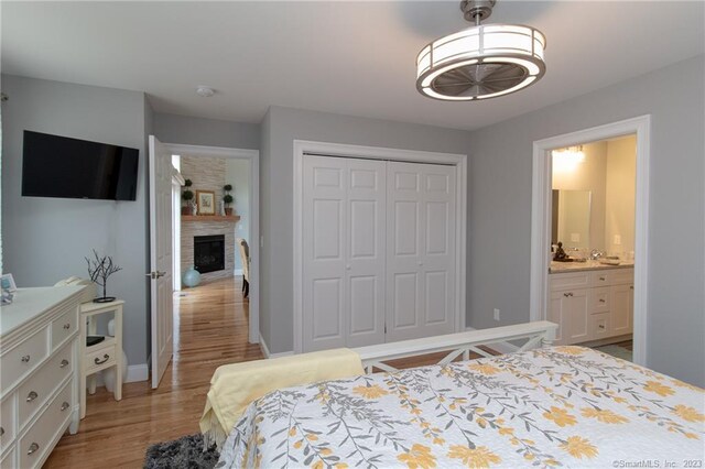 bedroom with light hardwood / wood-style flooring and a closet