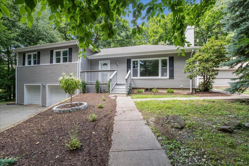 split level home with a garage and covered porch