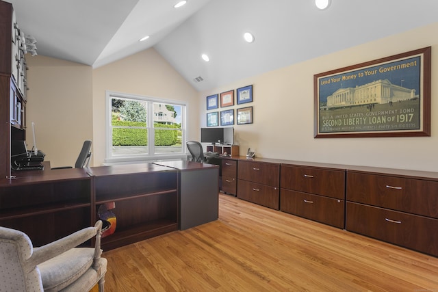 home office with vaulted ceiling and light hardwood / wood-style floors