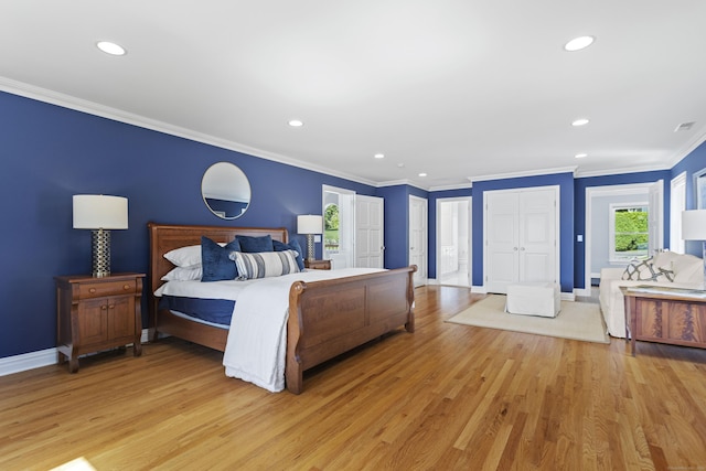 bedroom featuring crown molding and light wood-type flooring