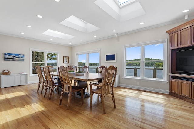 dining area featuring light hardwood / wood-style flooring and ornamental molding