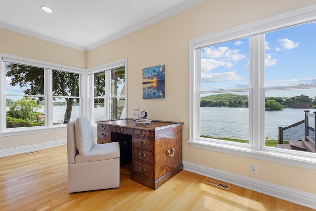 home office featuring a water view, ornamental molding, and light hardwood / wood-style floors