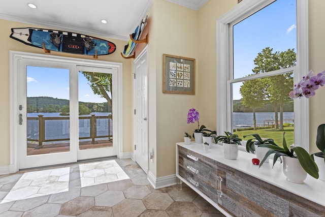 doorway featuring light tile patterned flooring, a water view, and ornamental molding