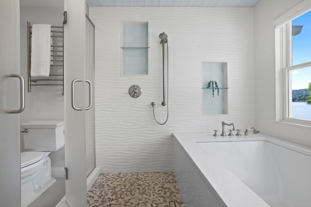 bathroom with tile patterned floors, shower with separate bathtub, and toilet