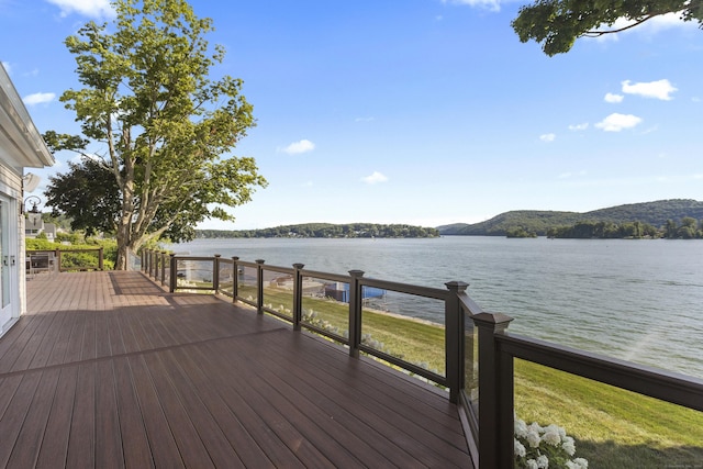 wooden deck featuring a water and mountain view