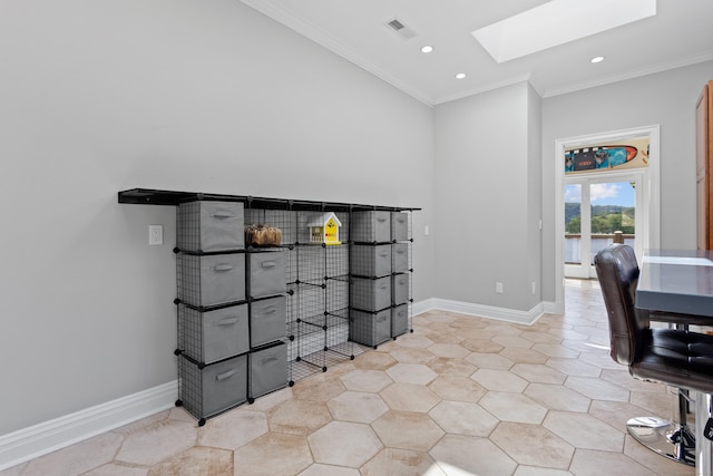 home office with a skylight, ornamental molding, and light tile patterned floors