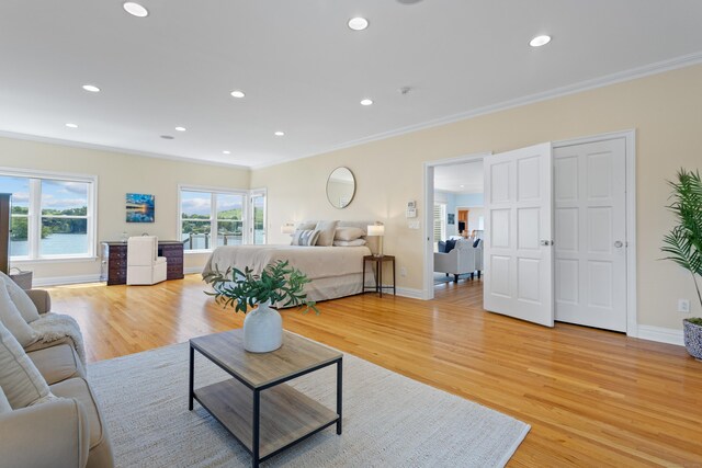 living room with light wood-type flooring and ornamental molding