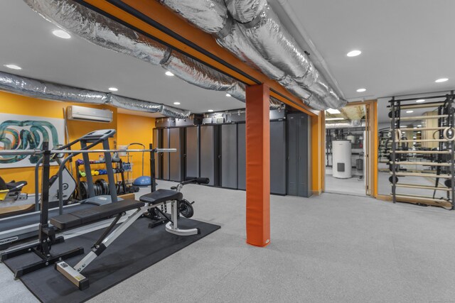 workout area featuring a wall mounted AC and water heater