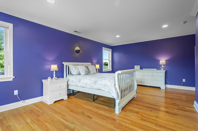 bedroom with multiple windows, crown molding, and light hardwood / wood-style floors