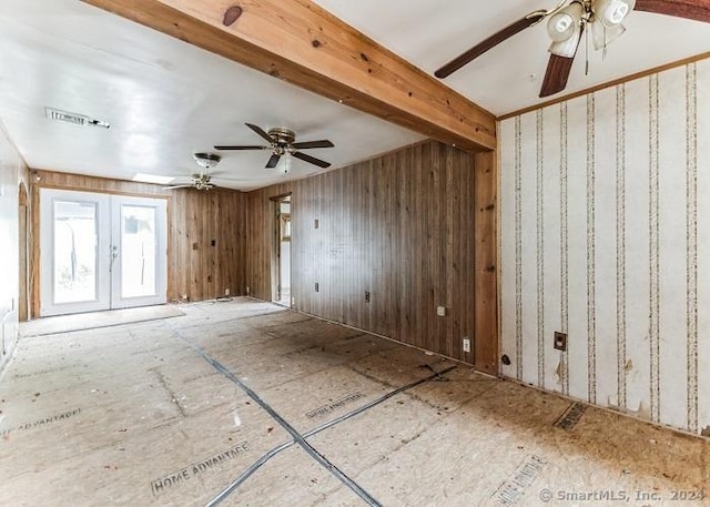 unfurnished room with beamed ceiling and french doors