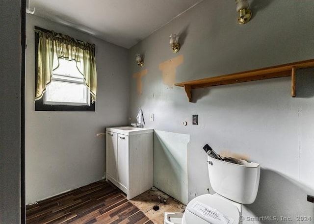 laundry room with dark wood-type flooring