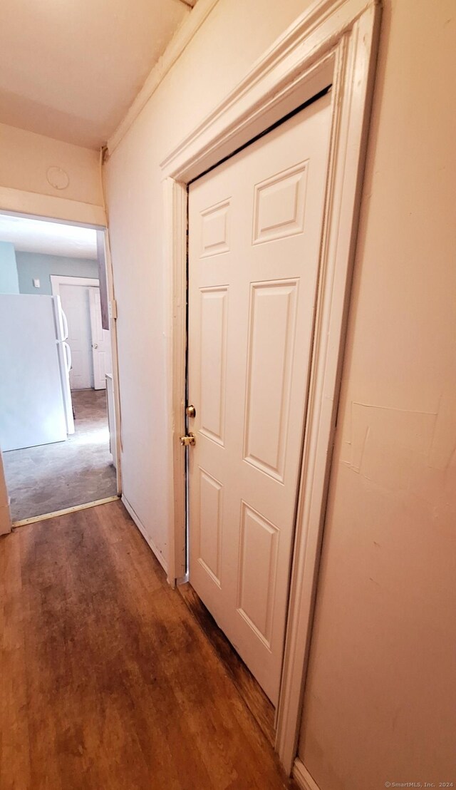 corridor with dark hardwood / wood-style flooring