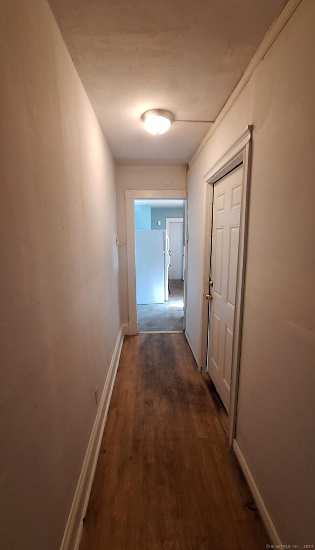 hallway with dark hardwood / wood-style floors