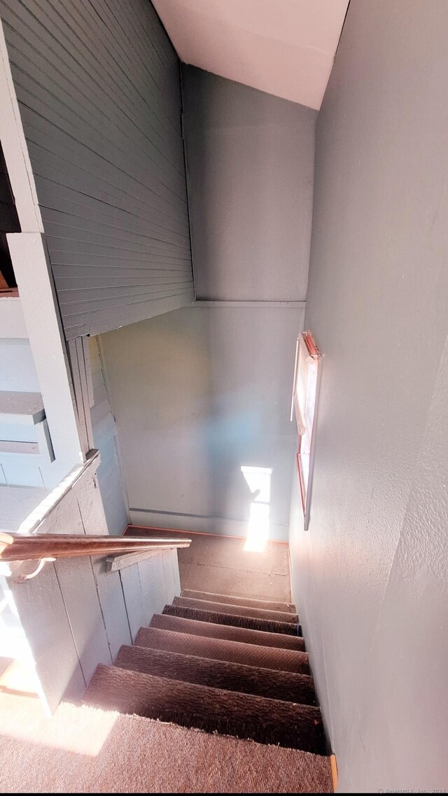 staircase featuring vaulted ceiling