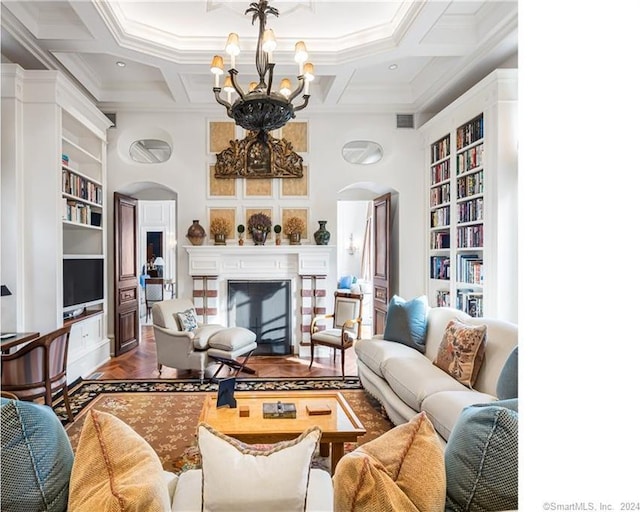 living room featuring built in features, coffered ceiling, and an inviting chandelier