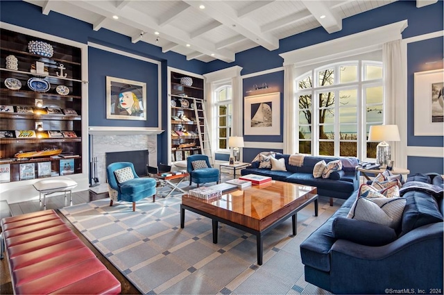 living room featuring a fireplace, built in shelves, and beam ceiling