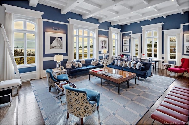 living room with hardwood / wood-style flooring, coffered ceiling, a wealth of natural light, and beam ceiling