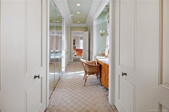 corridor featuring crown molding and light tile patterned floors