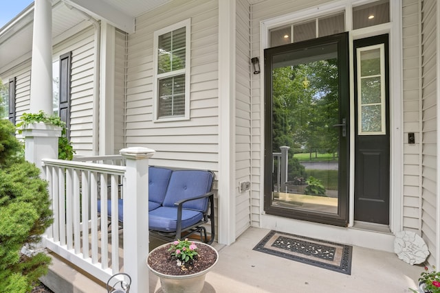 view of exterior entry featuring covered porch