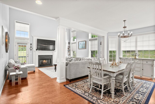 dining space featuring light hardwood / wood-style flooring and a notable chandelier