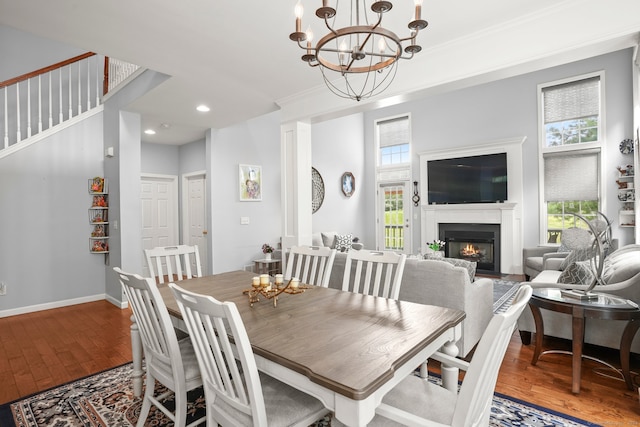 dining space featuring a notable chandelier, crown molding, and hardwood / wood-style floors