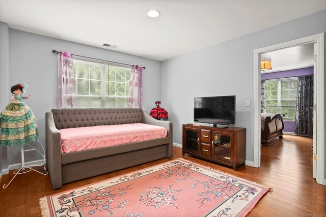 bedroom with hardwood / wood-style flooring