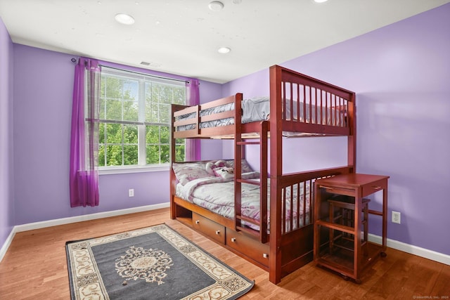 bedroom featuring recessed lighting, wood finished floors, visible vents, and baseboards