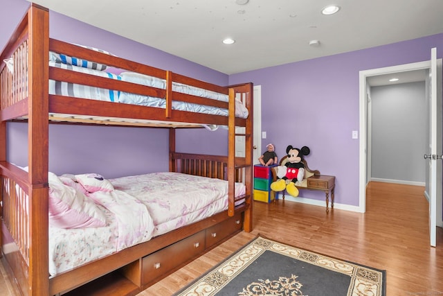 bedroom featuring recessed lighting, wood finished floors, and baseboards