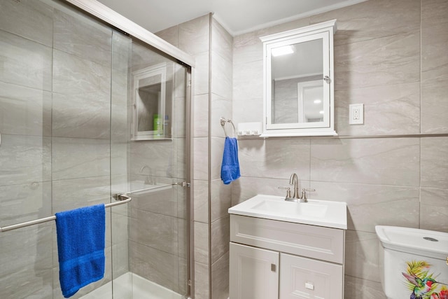 bathroom featuring toilet, a shower stall, tile walls, and vanity