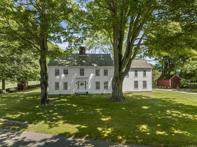 57 NW Corner Rd, Preston, CT 06365 - colonial-style house featuring a storage unit, an outdoor structure, a front lawn, and a chimney