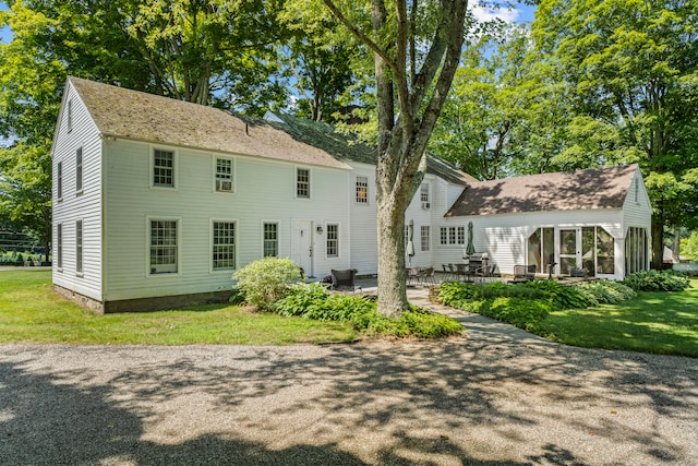 back of house featuring a patio area and a yard