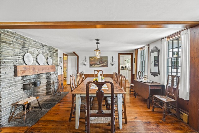 57 NW Corner Rd, Preston, CT 06365 - dining area featuring wood-type flooring, beamed ceiling, and a large fireplace