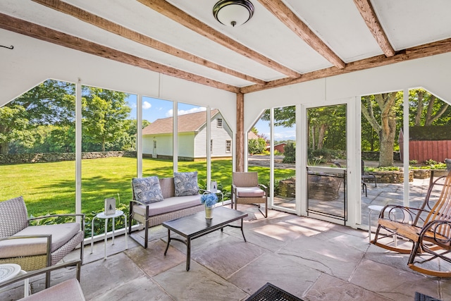 sunroom / solarium featuring beamed ceiling